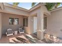 Inviting front porch with seating area and views of manicured landscaping at 1310 Ripplestone Ave, North Las Vegas, NV 89081