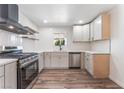 Modern kitchen featuring stainless steel appliances, white cabinetry, and hardwood floors at 1313 Purple Sage Ave, Las Vegas, NV 89108