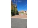Desert landscape lot with mature trees and views of the surrounding mountains at 1330 Honey Lake St, Las Vegas, NV 89110