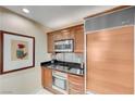 Modern kitchen featuring updated stainless steel appliances and sleek cabinetry at 135 E Harmon Ave # 2721, Las Vegas, NV 89109