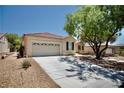 View of a single-story home with a two-car garage and low-maintenance desert landscaping at 1830 Lake Wales St, Henderson, NV 89052