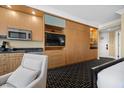 Living area with built-in storage, a kitchenette, and a view of the entrance at 2000 N Fashion Show Dr # 3000, Las Vegas, NV 89109