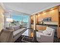 Comfortable living room with city views, featuring a sofa, armchair, and kitchenette with modern appliances at 2000 N Fashion Show Dr # 3000, Las Vegas, NV 89109