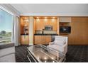 Relaxing living room with kitchenette, cabinets, and a large window offering city views at 2000 N Fashion Show Dr # 3000, Las Vegas, NV 89109