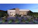 Beautiful backyard with modern landscaping, a fire pit, and access to the home at 25 Sand Star Ln, Henderson, NV 89011