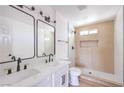 Updated bathroom featuring double sinks, black fixtures, and a walk-in shower at 2611 Siesta Ave, Las Vegas, NV 89121