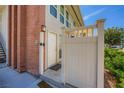Close-up of the property's front door featuring a decorative security fence, brick, and lighting at 2838 Geary Pl # 4017, Las Vegas, NV 89109