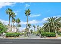 Elegant gated community showcasing well-manicured hedges and palm trees for added privacy at 3372 Westwind Rd, Las Vegas, NV 89146