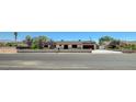 A single-story home with white walls, black shutters, and a brown roof as seen from the street at 3917 Leon Ave, Las Vegas, NV 89130