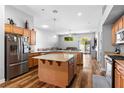 Spacious kitchen featuring stainless steel appliances, granite countertops, center island, and open floor plan at 4212 Helens Pouroff Ave, North Las Vegas, NV 89085