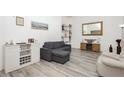 Bright living room with hardwood style floors and a comfortable gray couch, perfect for relaxation at 4232 Park Ct, Las Vegas, NV 89110