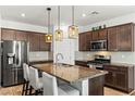 Modern kitchen with stainless steel appliances, granite countertops, and pendant lighting over the island at 438 Shimmering Sands Ave, North Las Vegas, NV 89031