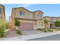 Two-story house with a two-car garage, small trees, and desert landscaping at 4641 Therapeutic St, North Las Vegas, NV 89031