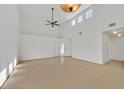 Spacious living room with light wood floors, a ceiling fan, and lots of natural light at 4708 Cohiba Way, North Las Vegas, NV 89031