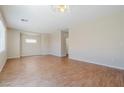 Large, bright living room featuring wood floors and neutral walls at 5282 Monterey Park Cir, Las Vegas, NV 89146