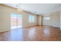 Spacious living room with wood floors and a sliding glass door to the backyard at 5282 Monterey Park Cir, Las Vegas, NV 89146