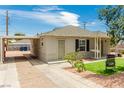 Inviting single-story home featuring a well-kept yard, covered parking, and a welcoming entrance at 531 New Mexico St, Boulder City, NV 89005
