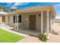 Inviting single-story home with a well-kept yard, quaint front porch, and charming details at 531 New Mexico St, Boulder City, NV 89005