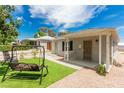 Charming single-story home showcasing a well-maintained yard and inviting front porch with swing at 531 New Mexico St, Boulder City, NV 89005