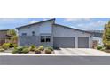 Modern home showcasing a two-car garage and professionally landscaped front yard at 5927 Villa Loma St, Las Vegas, NV 89148