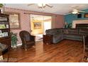 Cozy living room features hardwood floors, brick accent walls, and a comfortable sectional sofa at 624 N Bruce St, Las Vegas, NV 89101