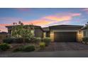 Charming single story home boasts desert landscaping, a brick driveway, and a spacious attached garage at 6421 Winecup St, Las Vegas, NV 89149