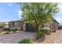 Single-story home featuring desert landscaping, a paver driveway and walkway, and a two car garage at 6421 Winecup St, Las Vegas, NV 89149