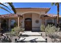 Elegant entryway with a double door entrance and manicured landscaping at 7250 Birkland Ct, Las Vegas, NV 89117