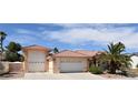 Three-car garage in a single-story home, boasting desert landscaping and beautiful architecture at 7250 Birkland Ct, Las Vegas, NV 89117