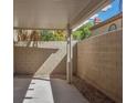 A cozy covered patio area with shade, offering an inviting outdoor space for relaxation at 7716 Bauble Ave, Las Vegas, NV 89128