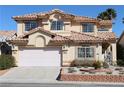 Two-story home showcasing a well-manicured yard, two-car garage, and a distinctive tile roof at 8982 Emerald Waters Ct, Las Vegas, NV 89147