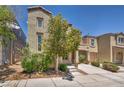 Charming two-story home with covered parking and mature landscaping in a well-maintained front yard at 9104 Pearl Cotton Ave, Las Vegas, NV 89149