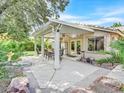 Inviting covered patio with dining set, ceiling fan, and access to the home through French doors at 9517 Mountainair Ave, Las Vegas, NV 89134