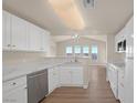 Modern eat-in kitchen featuring white cabinets, stainless steel appliances, and hardwood floors at 10001 Peace Way # 2322, Las Vegas, NV 89147