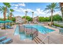 Resort-style community pool with palm trees, lounge chairs, and shallow wading area at 10001 Peace Way # 2322, Las Vegas, NV 89147