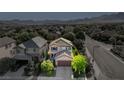Beautiful two-story home with a tile roof, lush landscaping, and an attached two-car garage in a well manicured neighborhood at 1013 Brinkman St, Las Vegas, NV 89138
