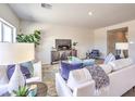 Comfortable living room with stylish decor, tile flooring, a cozy sofa, and a view into the dining area at 1301 Miller Springs Ln # Lot 93, North Las Vegas, NV 89084