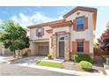Charming two-story home featuring stucco siding, decorative shutters, and a convenient attached two-car garage at 135 Manor House Ave, Las Vegas, NV 89123