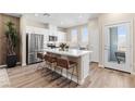 Bright kitchen featuring stainless steel appliances, white cabinetry, and a spacious quartz island with bar stool seating at 137 Harmonica Ave # Lot 19, Henderson, NV 89015