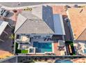 Aerial view of backyard showcasing a pool, spa, patio and manicured landscaping at 1523 Great Sands St, Boulder City, NV 89005