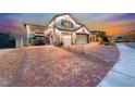 Paver driveway leading to a three-car garage and carport, enhancing the curb appeal of this residence at 1523 Great Sands St, Boulder City, NV 89005