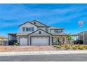 Charming two-story home with a spacious three-car garage, carport, landscaped front yard, and welcoming covered porch at 1523 Great Sands St, Boulder City, NV 89005