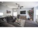 Cozy living room with plush sectional seating, modern decor, and stylish wood-look tile flooring at 1553 Bright View Dr, Las Vegas, NV 89119