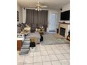Comfortable living room area complete with a fireplace, tile floors, and glass patio doors at 1617 Stonefield St, Las Vegas, NV 89144