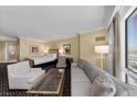 Open bedroom features a comfortable seating area, a luxurious bed, and a convenient bathroom at 2000 N Fashion Show Dr # 5617, Las Vegas, NV 89109