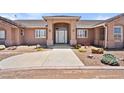 Inviting home exterior with a grand entrance and desert landscaping at 2031 Silver St, Pahrump, NV 89048
