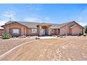 Expansive home features a desert landscape, charming facade, and circular drive at 2031 Silver St, Pahrump, NV 89048