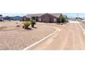 Oversized desert landscaped front yard with a long circular driveway at 2031 Silver St, Pahrump, NV 89048