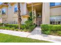 Inviting entryway with neat landscaping leads to the front door of the townhome at 2050 W Warm Springs Rd # 3624, Henderson, NV 89014