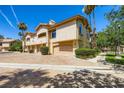 Charming exterior view of the townhome featuring well-maintained landscaping and private garages at 2050 W Warm Springs Rd # 3624, Henderson, NV 89014